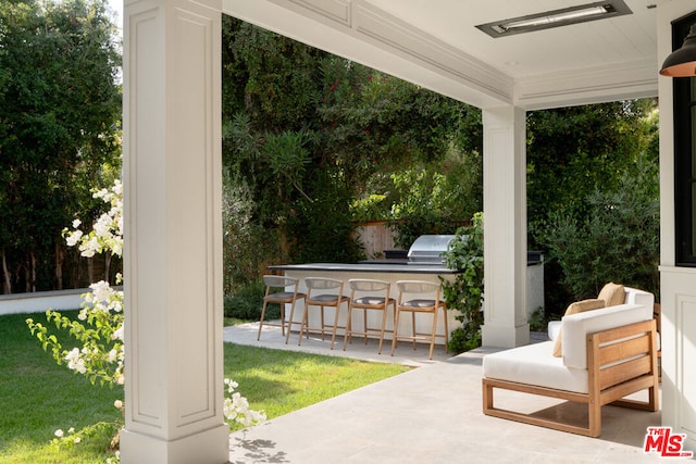 view of patio with grilling area and a bar