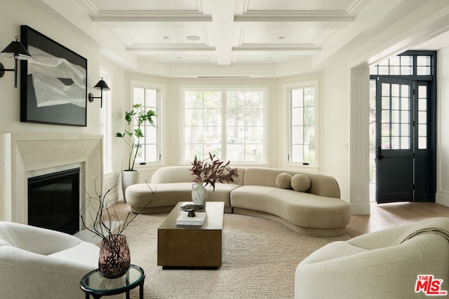 sunroom / solarium with beam ceiling, a high end fireplace, and coffered ceiling