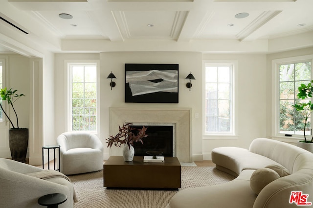 living room featuring a high end fireplace, a healthy amount of sunlight, and coffered ceiling