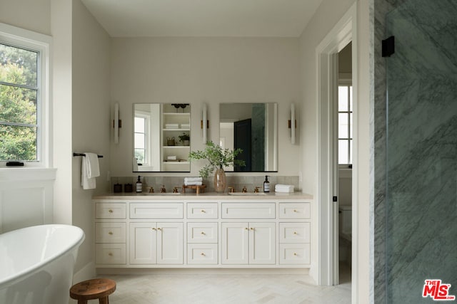 bathroom with vanity, independent shower and bath, and backsplash