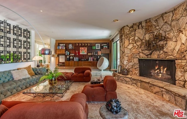 living room with a fireplace and carpet floors