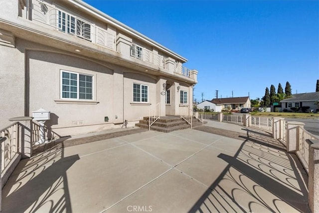 view of patio featuring a balcony