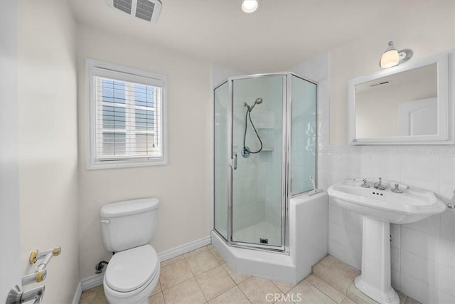 full bathroom with tile patterned flooring, visible vents, a stall shower, and toilet