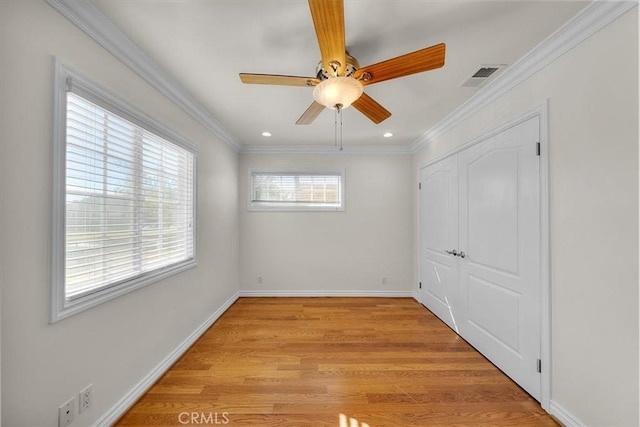 unfurnished bedroom featuring crown molding, baseboards, visible vents, and light wood finished floors