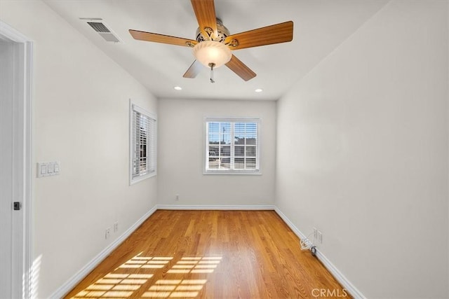 unfurnished room with a ceiling fan, visible vents, baseboards, recessed lighting, and light wood-style floors