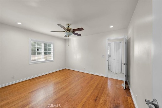 spare room featuring a ceiling fan, light wood-style flooring, recessed lighting, and baseboards