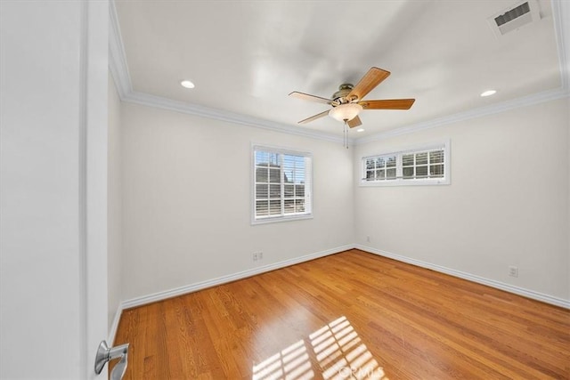 spare room featuring baseboards, visible vents, and ornamental molding