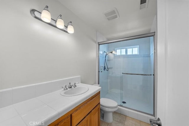 bathroom with tile patterned flooring, visible vents, a stall shower, and toilet