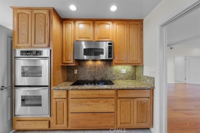 4601 W 191st St, Torrance, CA 90503 - kitchen featuring recessed lighting, light stone countertops, backsplash, and stainless steel appliances