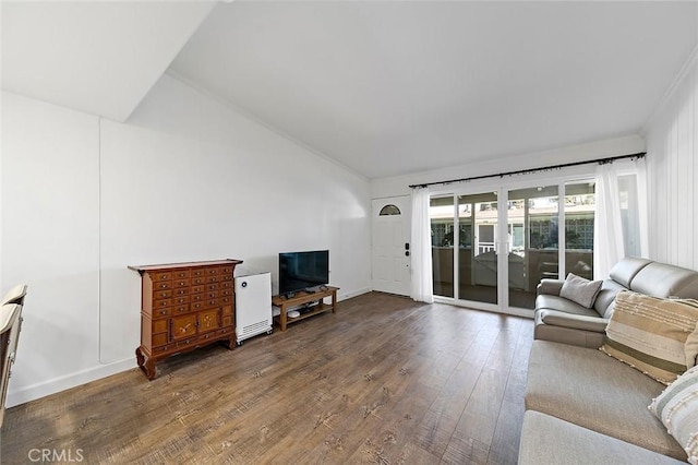 living room with dark wood-type flooring and vaulted ceiling