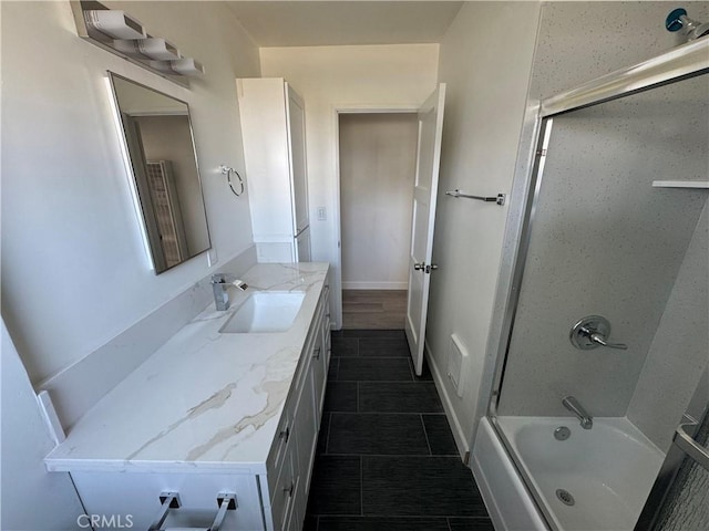 bathroom featuring tile patterned flooring, vanity, and shower / bath combination with glass door