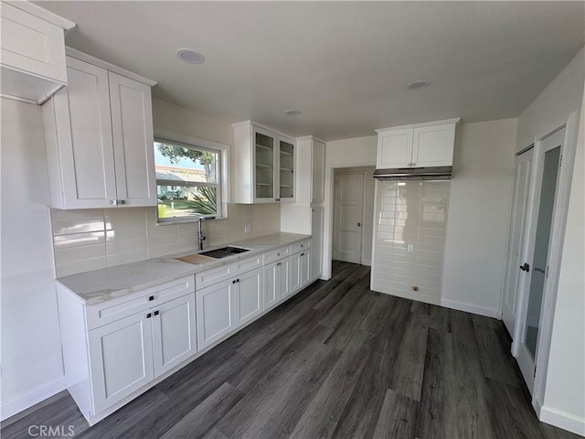 kitchen with white cabinets, dark hardwood / wood-style floors, and sink