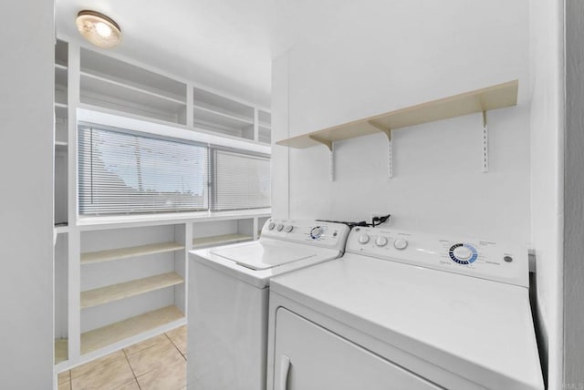 laundry room with light tile patterned floors and washer and dryer