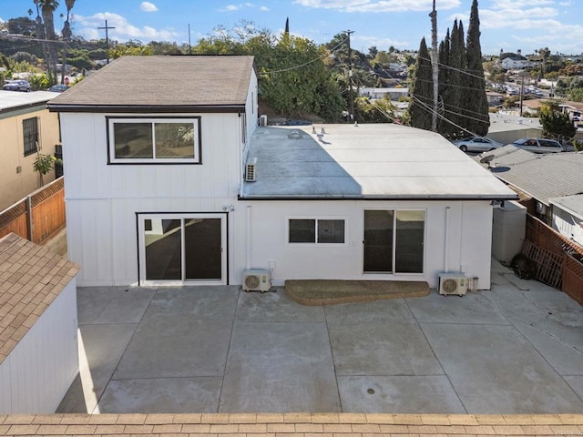 rear view of house with ac unit and a patio area