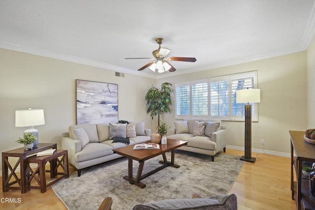 living room with crown molding, ceiling fan, and light wood-type flooring