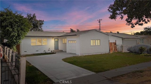 view of front facade with a garage and a lawn