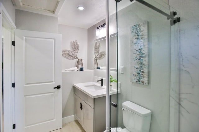 bathroom featuring toilet, a shower stall, recessed lighting, and vanity