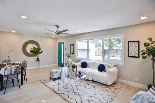 living room with baseboards, light wood-style flooring, and recessed lighting