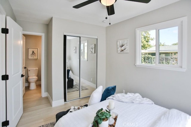 bedroom with light wood-style floors, a closet, baseboards, and a ceiling fan