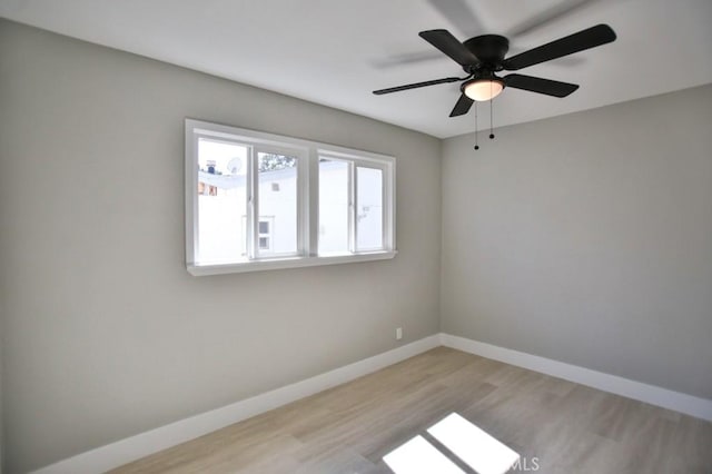 unfurnished room featuring light wood-style floors and baseboards