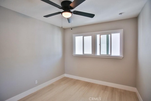 empty room featuring light wood-style flooring and baseboards