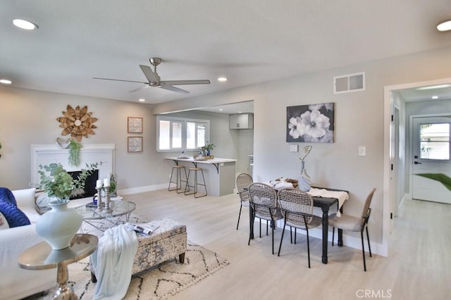 dining area featuring light wood-style flooring, plenty of natural light, visible vents, and recessed lighting