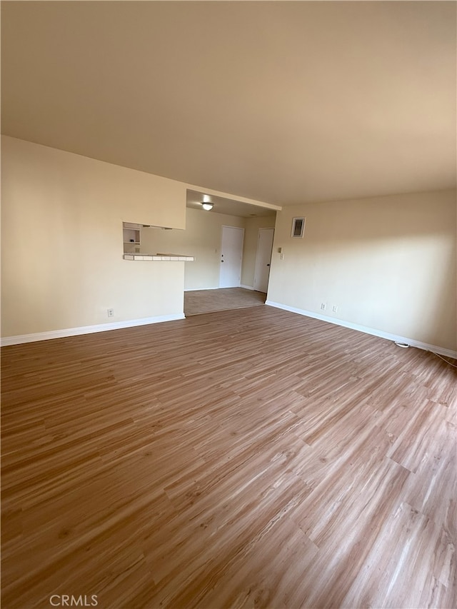 unfurnished living room featuring light wood-type flooring