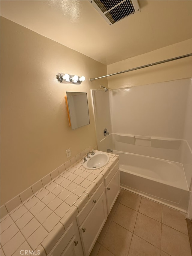 bathroom with tile patterned flooring, vanity, and shower / bath combination