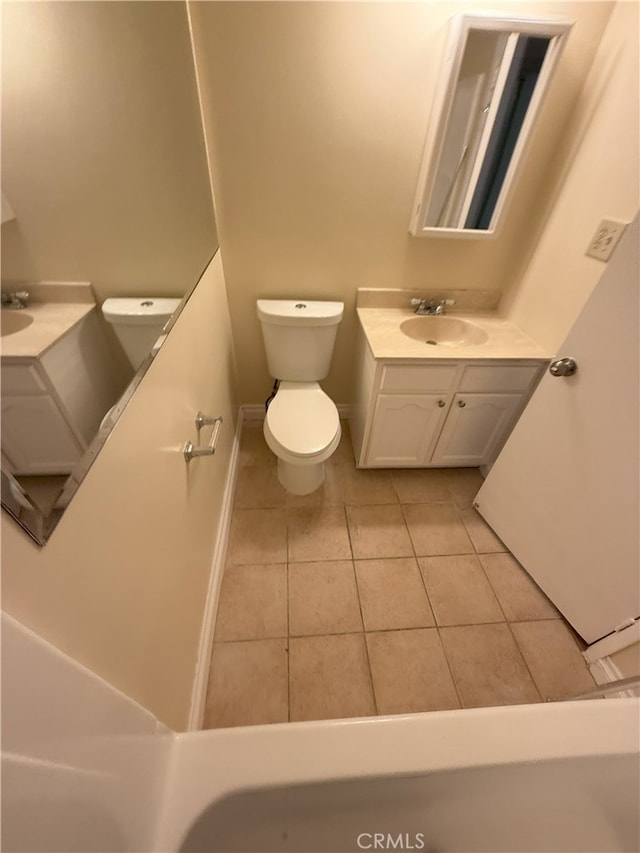 bathroom featuring tile patterned flooring, vanity, and toilet