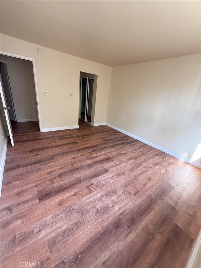 empty room with wood-type flooring