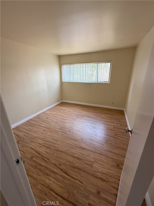 spare room with hardwood / wood-style floors