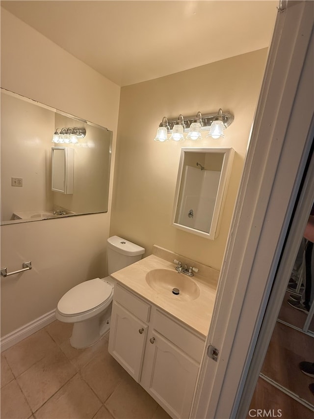 bathroom with tile patterned floors, vanity, and toilet