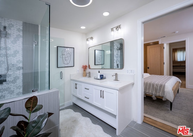 bathroom featuring tile patterned floors, an enclosed shower, and vanity