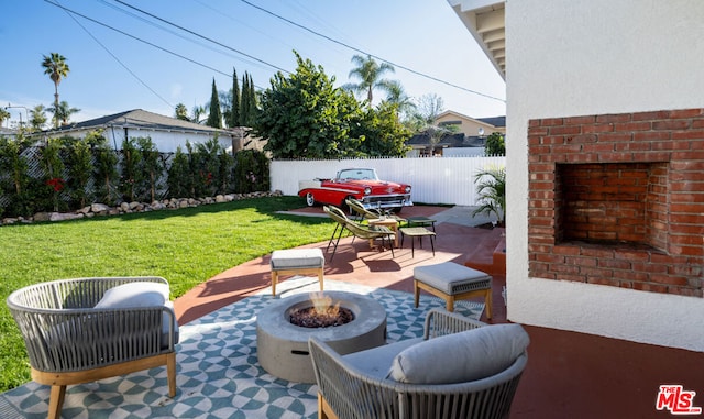 view of patio / terrace featuring a fireplace and a fire pit