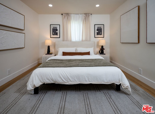 bedroom with hardwood / wood-style floors