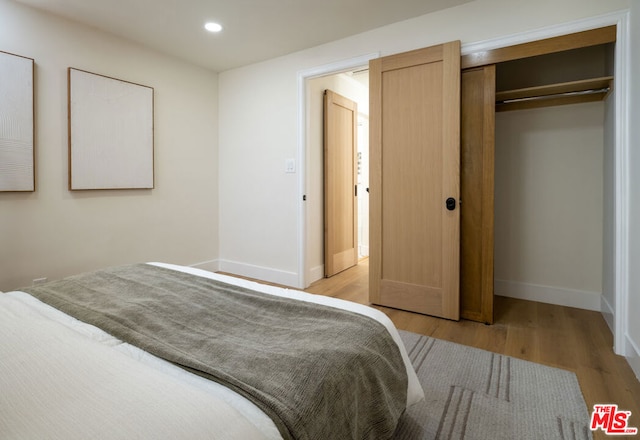 bedroom featuring a closet and light hardwood / wood-style floors