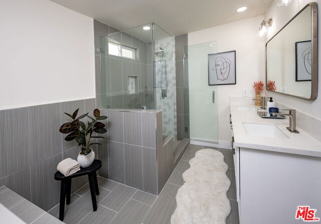 bathroom featuring an enclosed shower, vanity, and tile patterned flooring