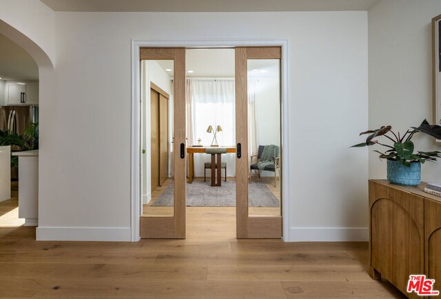 entryway featuring light hardwood / wood-style flooring and french doors