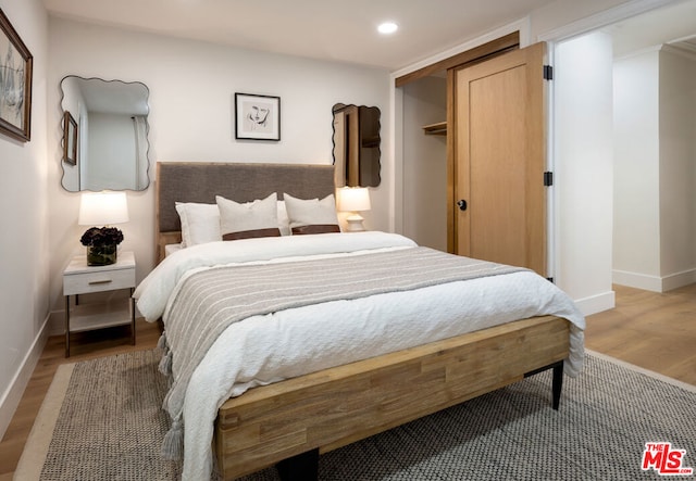 bedroom with a closet and light wood-type flooring