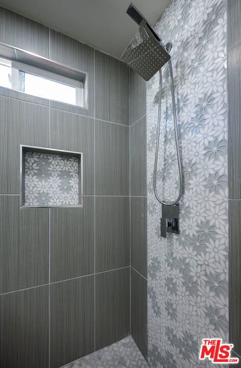 bathroom with tiled shower