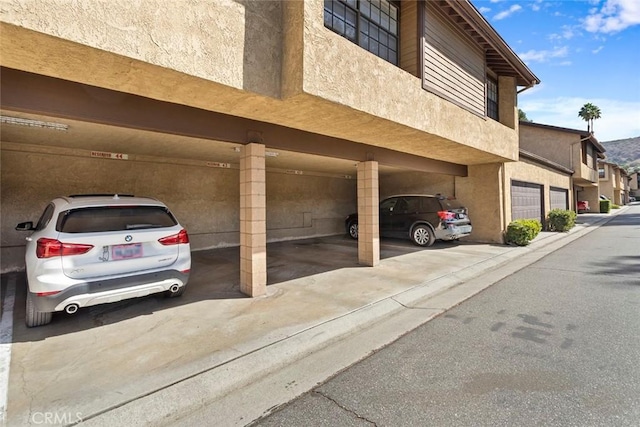 view of car parking featuring a garage