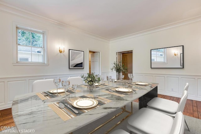 dining space with dark hardwood / wood-style flooring and ornamental molding