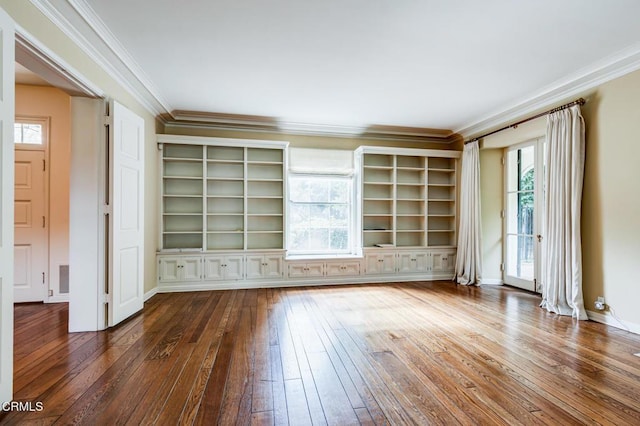 unfurnished living room with ornamental molding, dark hardwood / wood-style flooring, and built in features