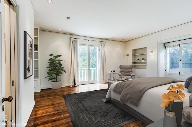 bedroom featuring dark hardwood / wood-style flooring and access to outside