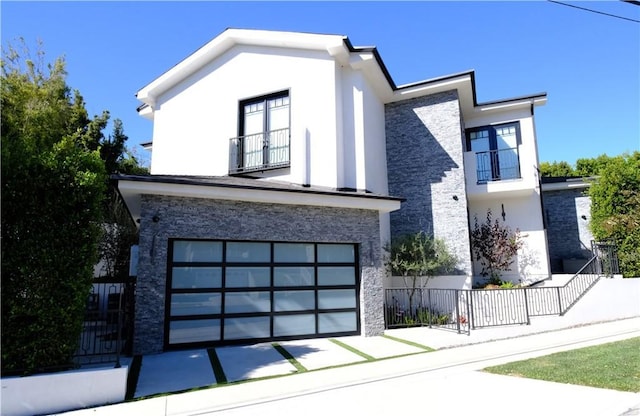 view of front of house featuring a garage and a balcony