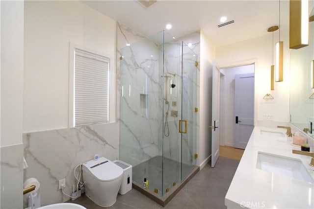 bathroom featuring toilet, tile walls, a shower with shower door, and vanity