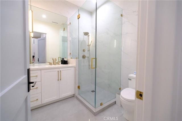 bathroom with vanity, toilet, and an enclosed shower