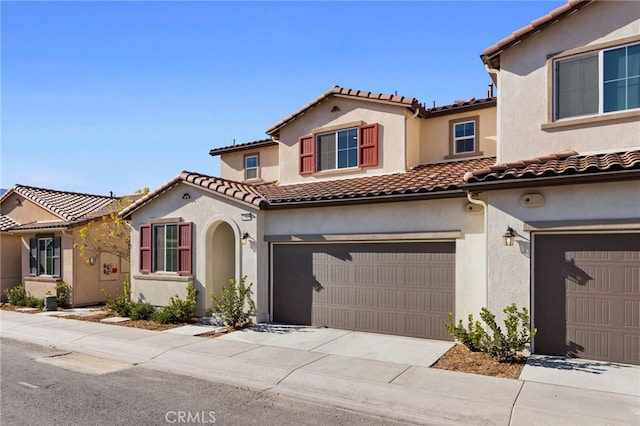 mediterranean / spanish-style home with a garage