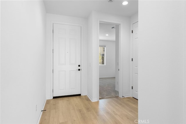 hall with light hardwood / wood-style flooring