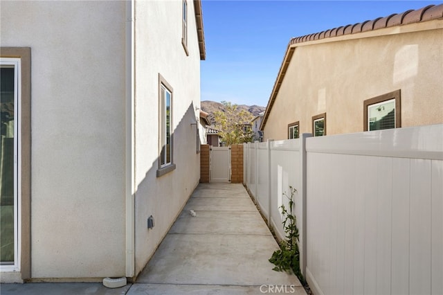 view of side of home with a mountain view